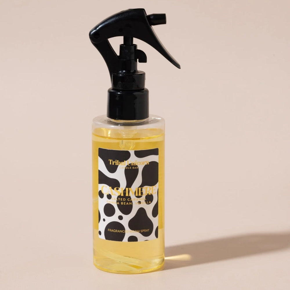 Spray bottle with black and white label on beige background