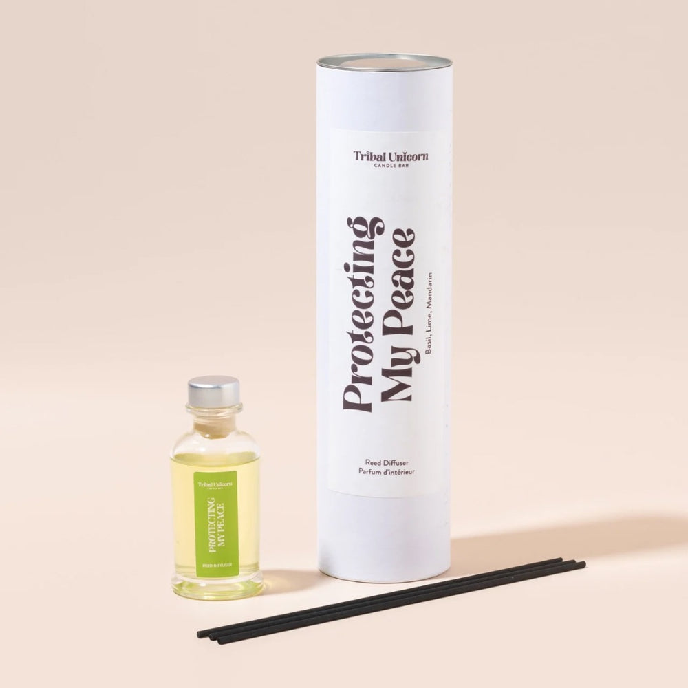 
                  
                    Reed Diffuser with bottle, cylindrical container, and black sticks on a beige background
                  
                