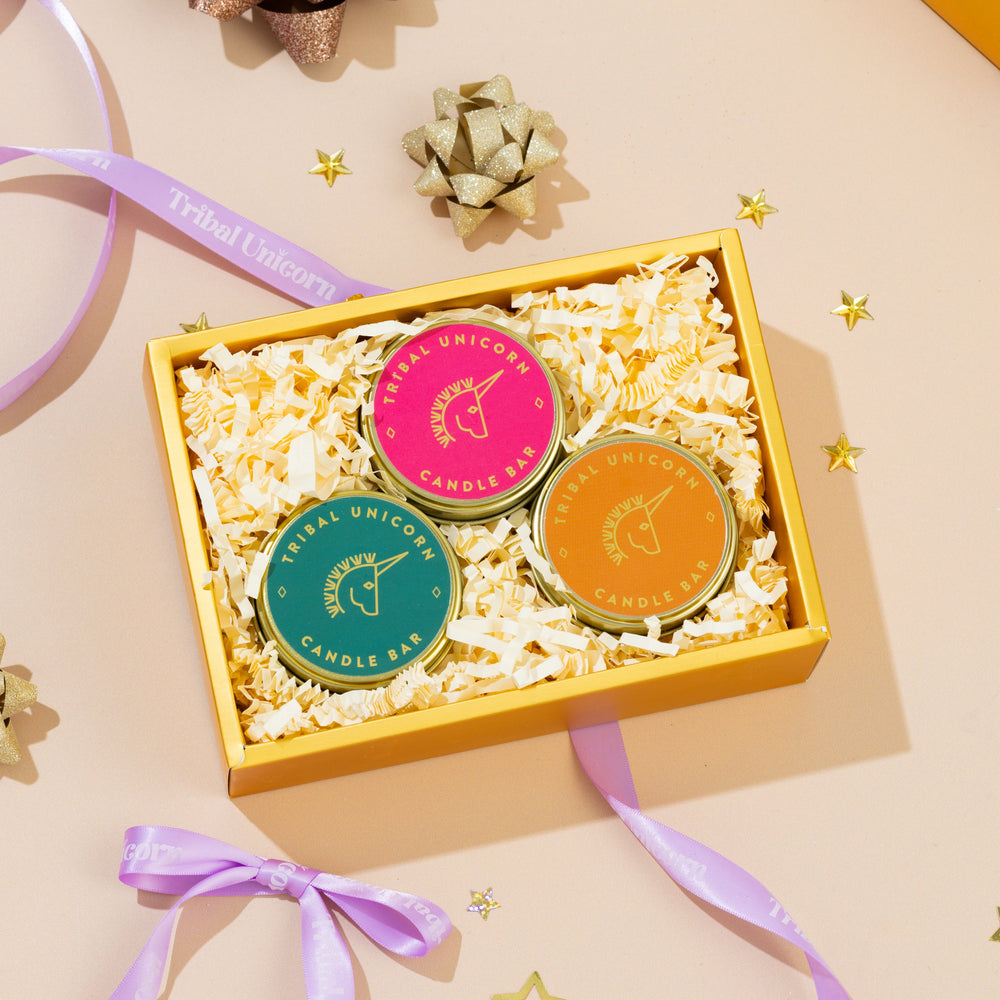 
                  
                    Four colorful candle bars in a box with decorative ribbons on a light background
                  
                